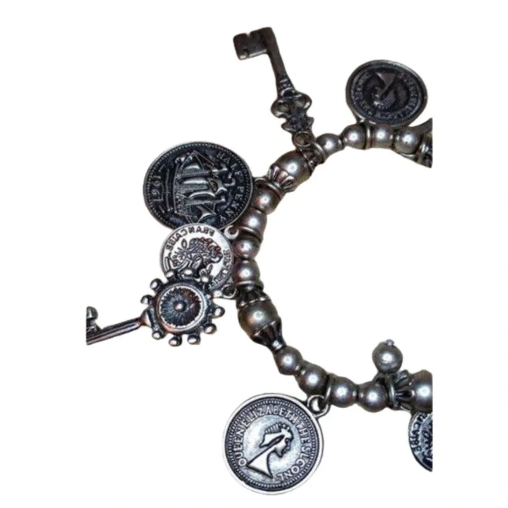 𝅺Vintage roll on dangle charm bracelet with coins and keys antique silver tone.